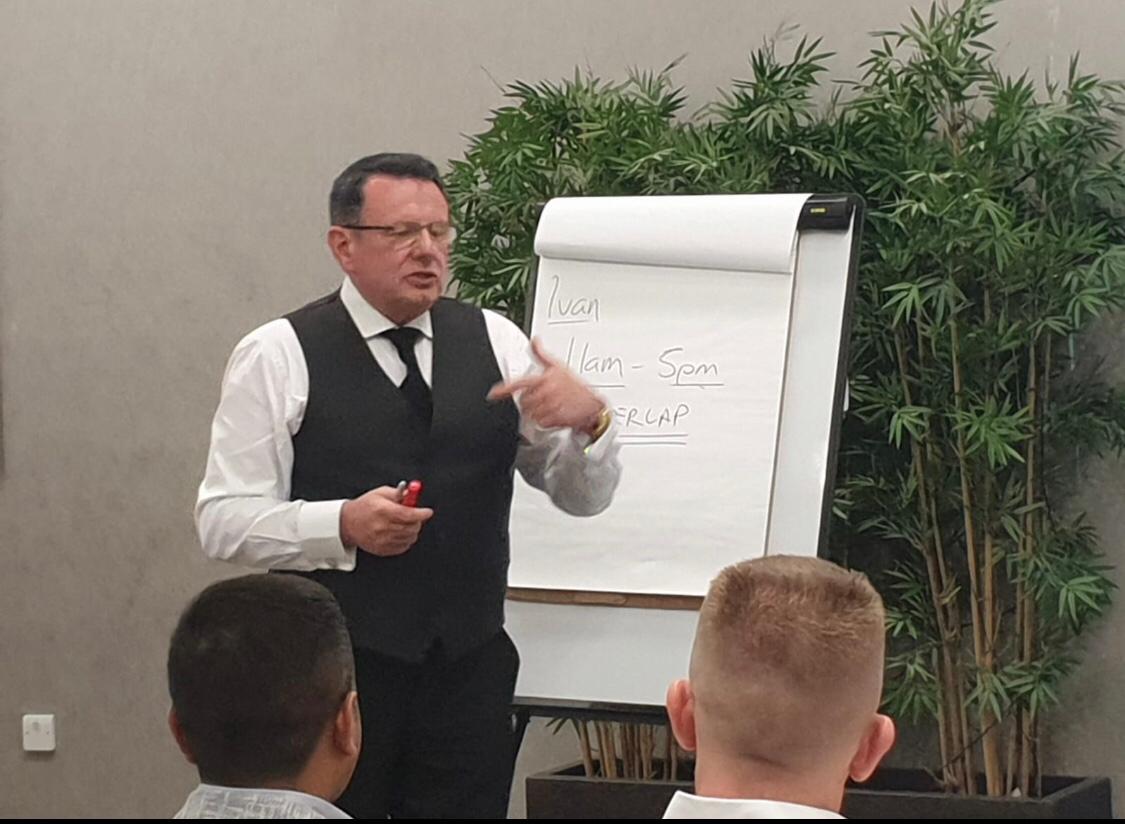 Ivan teaching market concepts at a flip chart